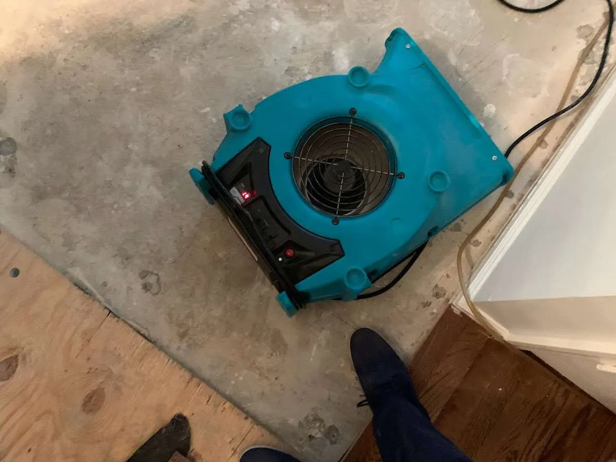 Air mover drying subfloor during Commercial Water Damage Restoration in Leesville